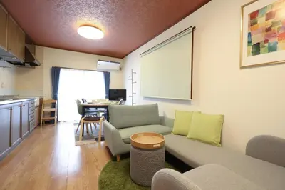 a living room with a couch and a table at \u8c4a\u6d32\u671d\u51ea\u306e\u5bbf in Tokyo
