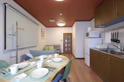 a kitchen with a table and a dining room at \u8c4a\u6d32\u671d\u51ea\u306e\u5bbf in Tokyo