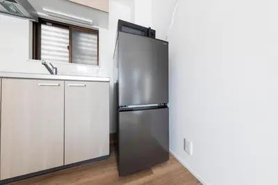 a stainless steel refrigerator in a kitchen with a sink at \u3077\u3075\u304b\u9580\u524d\u4ef2\u753a Pufuka Monzennakacho in Tokyo