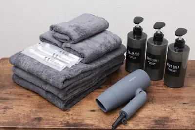 a wooden table with towels and a hair dryer and a heat gun at jjn\u4ef2\u753a201 in Tokyo