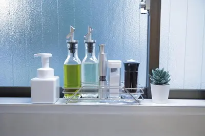 a bathroom counter with bottles of soap and a mirror at \u9577\u671f\u5272\u304c\u304a\u5f97 \u6700\u59274\u540d \u897f\u5927\u5cf6\u99c5\u5f92\u6b693\u5206 \u65b0\u5bbf\u76f4\u901a20\u5206\u6771\u4eac\u6ede\u5728\u306b\u6700\u9069TDR \u30b9\u30ab\u30a4\u30c4\u30ea\u30fc\u597d\u30a2\u30af\u30bb\u30b9HOTEL DREAM MUSIC Lavender TOKYO in Tokyo