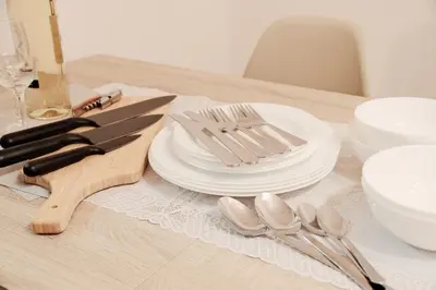 a table with white plates and silverware on it at Setagaya Quiet Residential Apartment203 in Tokyo