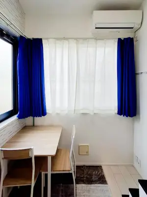 a room with a desk and a window with blue curtains at Triphome Otsuka 4 mins ShinOtsuka Station Loft bed in Tokyo