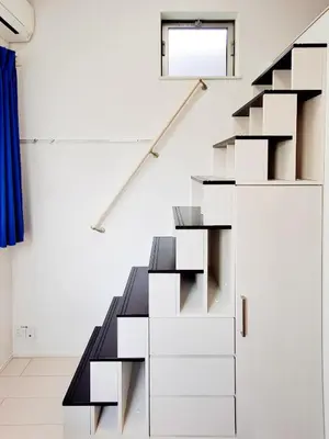a staircase in a room with white walls at Triphome Otsuka 4 mins ShinOtsuka Station Loft bed in Tokyo