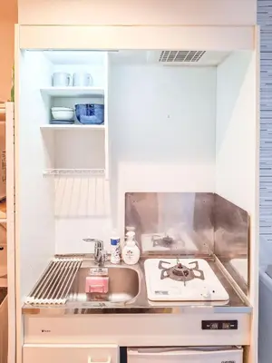 a kitchen with a sink and a stove at Triphome Otsuka 4 mins ShinOtsuka Station Loft bed in Tokyo