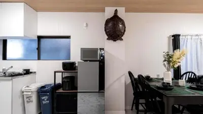 a kitchen and dining room with a table and a refrigerator at Kasai disney access hotel in Tokyo