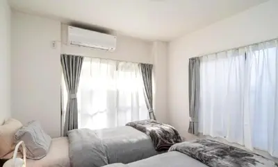 a bedroom with two beds in front of a window at Kasai disney access hotel in Tokyo