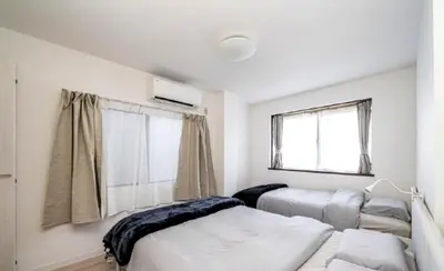 a bedroom with two beds and a window at Kasai disney access hotel in Tokyo