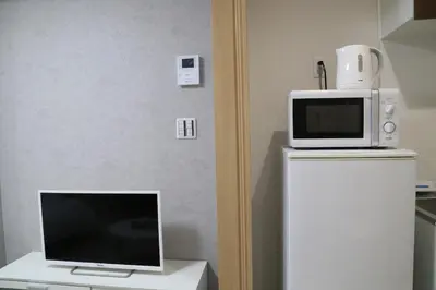 a microwave and a television on top of a refrigerator at M15 Aoba Great location within walking distance of Ikebukuro in Tokyo