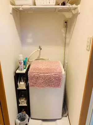 a small refrigerator in a room with a shelf at HOTEL k &m in Tokyo