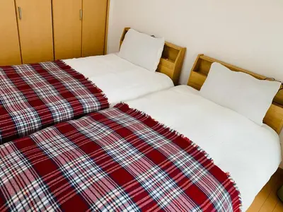 two beds sitting next to each other in a room at HOTEL k &m in Tokyo