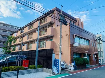 a pink building on a city street at HOTEL k &m in Tokyo