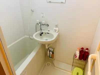 a small bathroom with a sink and a bath tub at HOTEL k &m in Tokyo