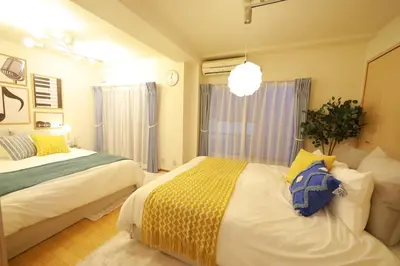 a bedroom with two beds and a blue backpack at \u9577\u671f\u5272\u304c\u304a\u5f97 \u6700\u59274\u540d \u897f\u5927\u5cf6\u99c5\u5f92\u6b693\u5206 \u65b0\u5bbf\u76f4\u901a20\u5206\u6771\u4eac\u6ede\u5728\u306b\u6700\u9069TDR \u30b9\u30ab\u30a4\u30c4\u30ea\u30fc\u597d\u30a2\u30af\u30bb\u30b9HOTEL DREAM MUSIC Melody Sky in Tokyo