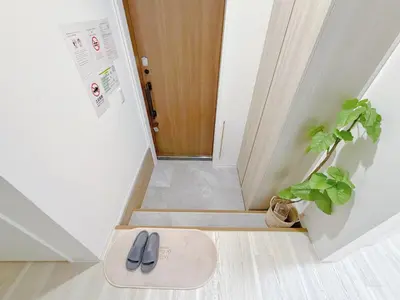 a pair of shoes on a mat in front of a door at Mori Hosue \u8d64\u7fbd\u5357 in Tokyo