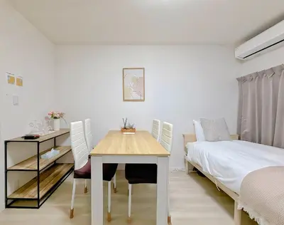 a bedroom with a table and a bed and a desk at Mori Hosue \u8d64\u7fbd\u5357 in Tokyo