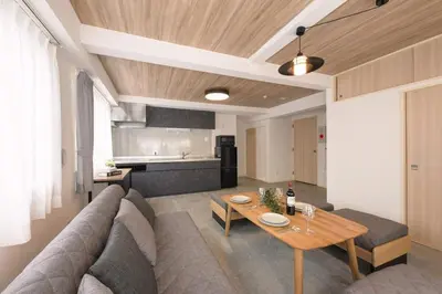 a living room with a couch and a table at Shinjuku 6-chome City Stay 4F \u65b0\u5bbf6\u4e01\u76ee \u30b7\u30c6\u30a3\u30b9\u30c6\u30a4 4F in Tokyo