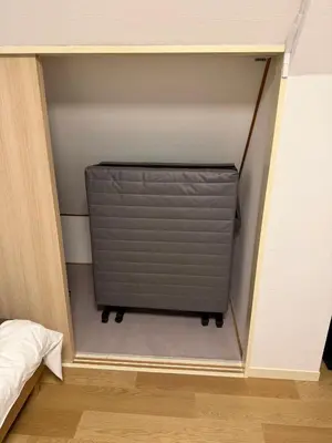 a room with a shutter in the corner of a room at Shinjuku 6-chome City Stay 4F \u65b0\u5bbf6\u4e01\u76ee \u30b7\u30c6\u30a3\u30b9\u30c6\u30a4 4F in Tokyo