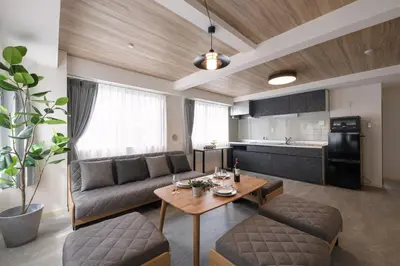 a living room with a couch and a table at Shinjuku 6-chome City Stay 4F \u65b0\u5bbf6\u4e01\u76ee \u30b7\u30c6\u30a3\u30b9\u30c6\u30a4 4F in Tokyo