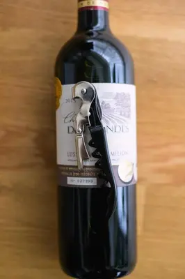 a bottle of red wine sitting on a table at Shinjuku 6-chome City Stay 4F \u65b0\u5bbf6\u4e01\u76ee \u30b7\u30c6\u30a3\u30b9\u30c6\u30a4 4F in Tokyo