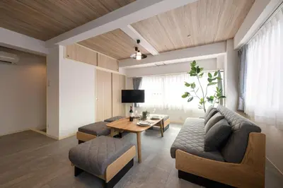 a living room with a couch and a table at Shinjuku 6-chome City Stay 4F \u65b0\u5bbf6\u4e01\u76ee \u30b7\u30c6\u30a3\u30b9\u30c6\u30a4 4F in Tokyo