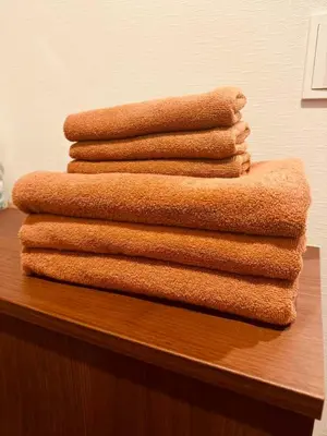 a stack of towels sitting on top of a table at Nexus Villa Morishita in Tokyo