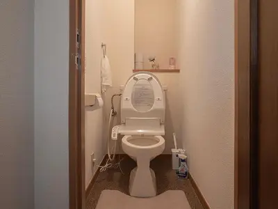 a small bathroom with a toilet with the lid up at \u685c\u306e\u5ddd79 \u5317\u5343\u4f4f\u5bb6\u5ead\u516c\u5bd36-8\u4eba\u4e28Kita Senju family apartments for 6-8 people in Tokyo