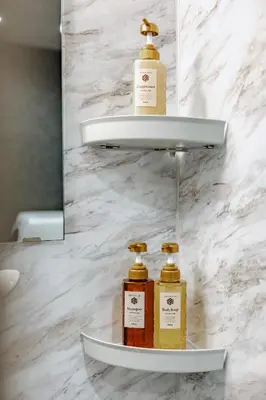 three bottles of oils sitting on a shelf in a bathroom at tsukiji 2min,V101,Ginza 10min in Tokyo