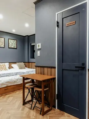 a room with a bed and a table and a door at tsukiji 2min,V101,Ginza 10min in Tokyo