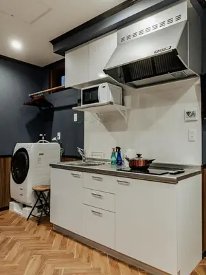 a kitchen with white cabinets and a stove top oven at tsukiji 2min,V101,Ginza 10min in Tokyo