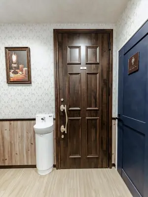 a bathroom with a toilet and a wooden door at tsukiji 2min,V101,Ginza 10min in Tokyo