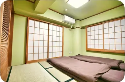a room with a bed and two large windows at Alice Room\u677f\u6a4b501 in Tokyo