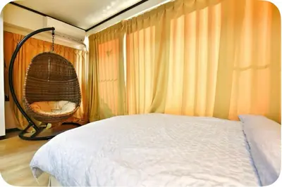 a bedroom with a bed and a hanging chair at Alice Room\u677f\u6a4b501 in Tokyo