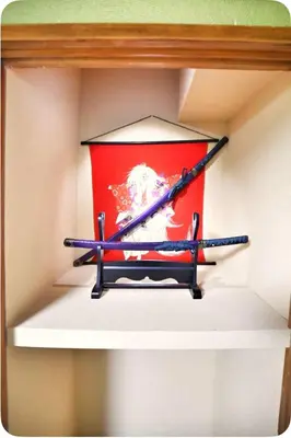 a shelf with three hockey sticks in a box at Alice Room\u677f\u6a4b501 in Tokyo