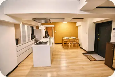 a kitchen and dining room with a table in the background at Alice Room\u677f\u6a4b501 in Tokyo