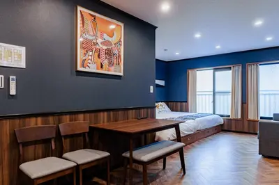 a room with a bed and a table and chairs at tsukiji 2min,V201,Ginza 10min in Tokyo