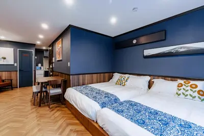 a bedroom with two beds and a table in it at tsukiji 2min,V201,Ginza 10min in Tokyo