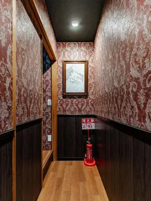 a hallway with red wallpaper and a sign on the wall at tsukiji 2min,V201,Ginza 10min in Tokyo