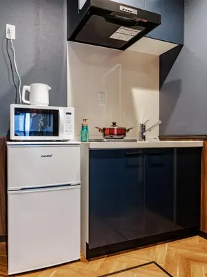 a kitchen with a microwave and a stove at tsukiji 2min,V201,Ginza 10min in Tokyo
