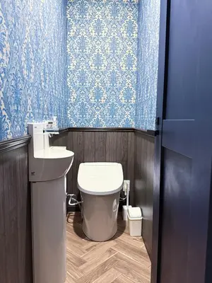 a bathroom with a toilet and a sink and blue wallpaper at tsukiji 2min,V301,Ginza 10min in Tokyo