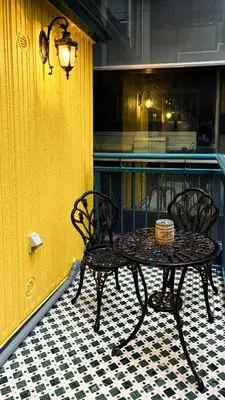 a table and chairs next to a yellow wall at tsukiji 2min,V301,Ginza 10min in Tokyo