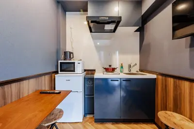 a small kitchen with a table and a microwave at tsukiji 2min,V301,Ginza 10min in Tokyo
