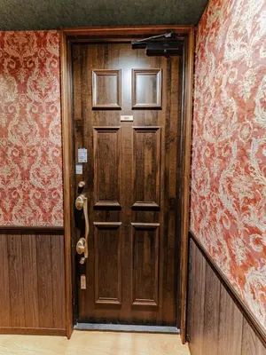 a wooden door in a room with red wallpaper at tsukiji 2min,V301,Ginza 10min in Tokyo