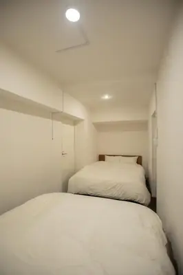 a bedroom with a white bed in a room at NIYS apartments 74type in Tokyo