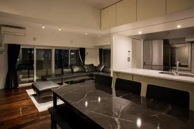 a living room with a couch and a table at NIYS apartments 74type in Tokyo