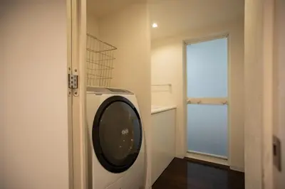 a washing machine in a room with a window at NIYS apartments 74type in Tokyo