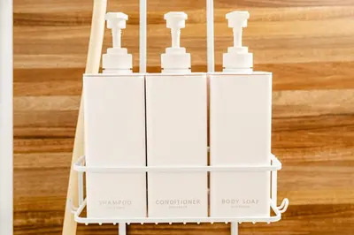 a white shelf with four bottles on it at Lions Mansion SHIBUYA 219 in Tokyo