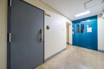 a row of doors in a hospital hallway with blue doors at Lions Mansion SHIBUYA 219 in Tokyo