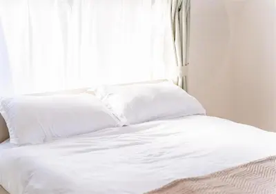 a white bed with white sheets and a window at 8min to Keisei Hikifune Entire House Sleeps12 in Tokyo