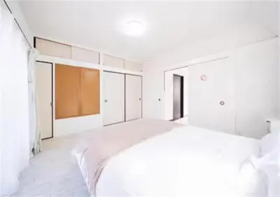 a white bedroom with a large bed in it at 8min to Keisei Hikifune Entire House Sleeps12 in Tokyo